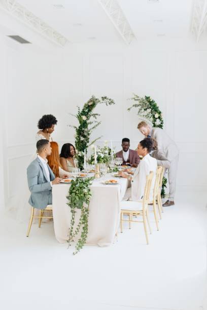 istock Newlyweds having fun with their friends at the wedding reception 1320301327