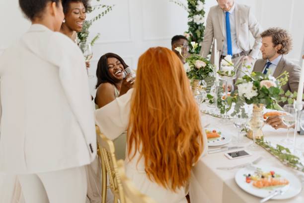 istock Newlyweds having fun with their friends at the wedding reception 1320301329