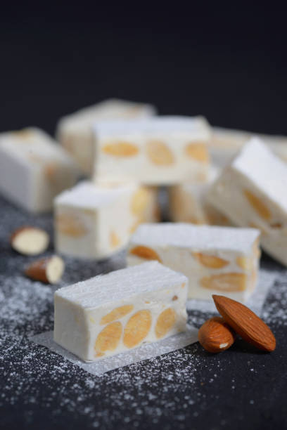 istock White nougat with almonds on black ardesia plate 1320302813