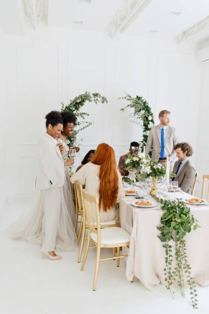 istock Newlyweds having fun with their friends at the wedding reception 1320302875