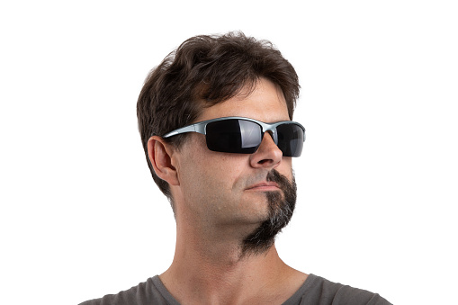 split personality - portrait of ordinary forty - 40 years old bearded man with half shaved and unshaven face with sunglasses isolated on white