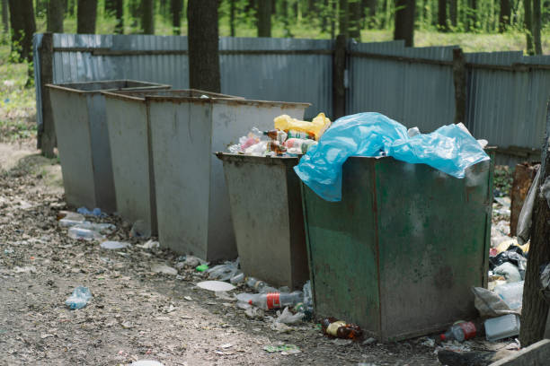 istock Large trash cans in the forest. Garbage in the forest 1320306531