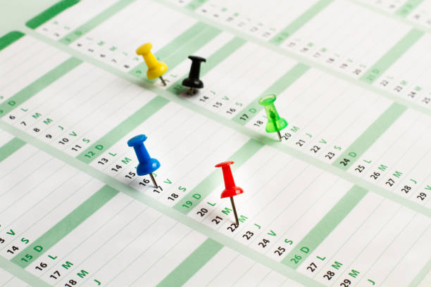 istock A daily calendar with colored pushpins marking some days 1320307846