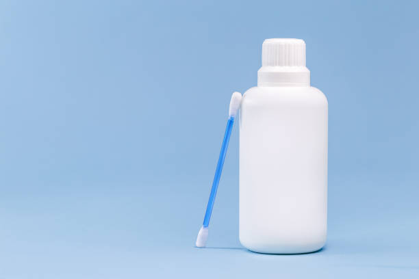 istock plastic container, bottle of antiseptic hydrogen peroxide with cotton, medicine with blue background without label 1320308446