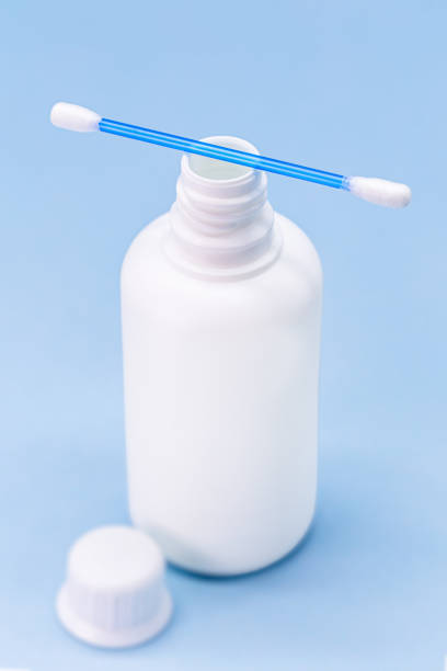 istock hydrogen peroxide, in white plastic bottle, with cotton swab and isolated blue background, medicine concept, medicine for wounds and small cuts 1320308981