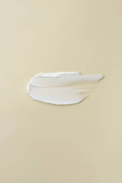 Cosmetic cream smear, on a beige background.
