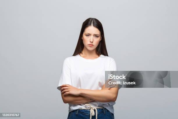 Portrait Of Displeased Young Woman Stock Photo - Download Image Now - 20-24 Years, Adult, Adults Only