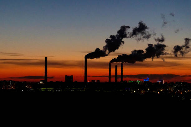 Smoke from industrial chimneys at sunset. Toxic smoke from a thermal power plant in an industrial area. Industrial landscape