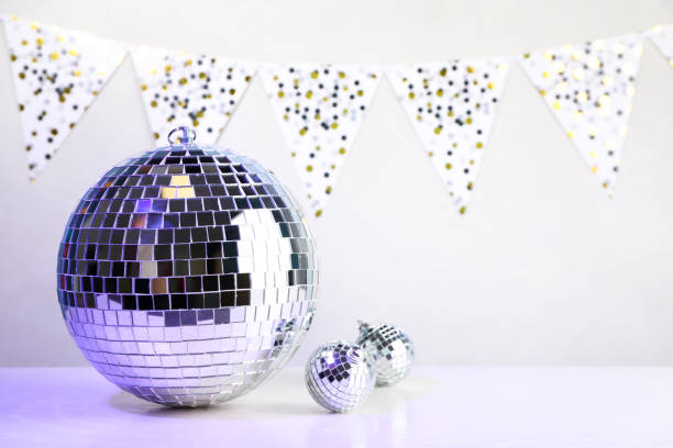 istock Shiny disco balls on white wooden table. Space for text 1320314323