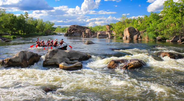 Pacuare River, Costa Rica -MAY  15 2021: Rafting team , summer extreme water sport. Group of people in a rafting boat, beautiful adrenaline ride down the river.