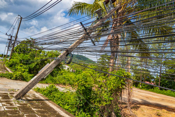 istock Power pole overturned with absolute cable chaos in Thalang Phuket Thailand. 1320317134