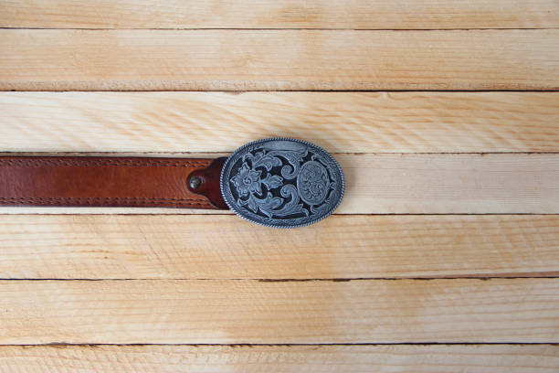 istock Leather cowboy belt on wooden background 1320317358
