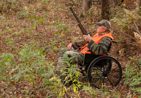 hunter in a wheelchair in the Autumn woods