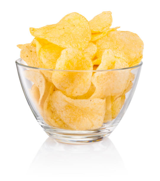 istock Potato chips in glass bowl isolated on white background 1320321048