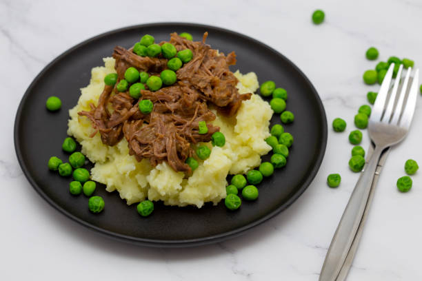 istock Butterflied beef with mashed potatoe and peas 1320321071