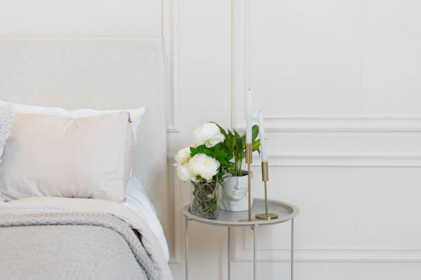 istock Flowers, candles and potted plant on bedside table 1320321107