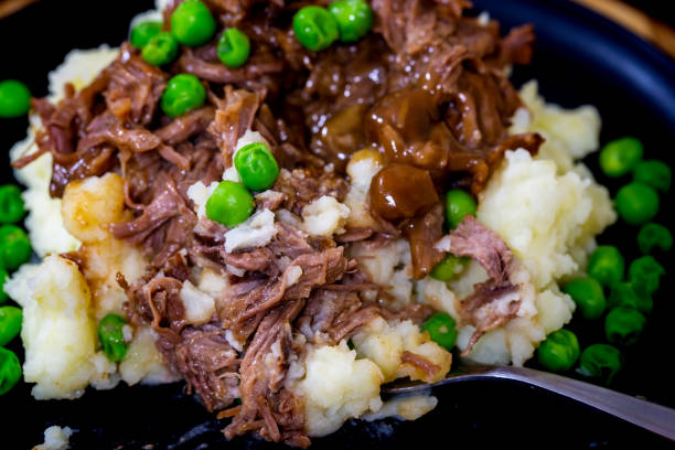 istock Butterflied beef with mashed potatoe and peas 1320321155