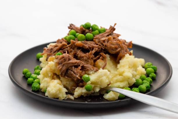 istock Butterflied beef with mashed potatoe and peas 1320321279