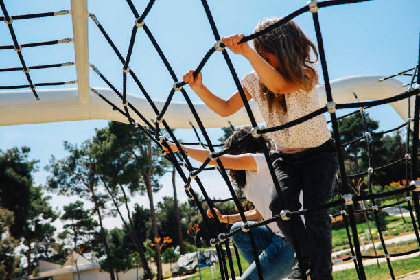 istock Mom having fun with daughter at the playground 1320321448