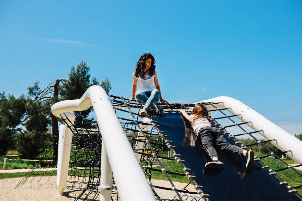 istock Mom having fun with daughter at the playground 1320321726
