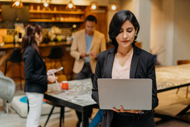 istock Confidence Indian businesswoman using laptop in co-working space 1320321876