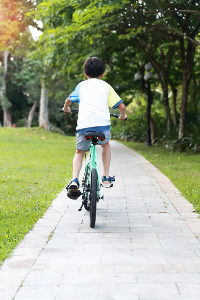 istock Chinese boy riding a bike 1320322030
