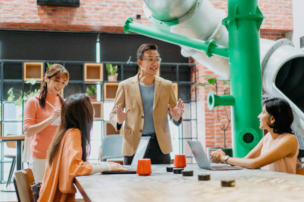 istock Asian businessman giving presentation in co-working space 1320322082