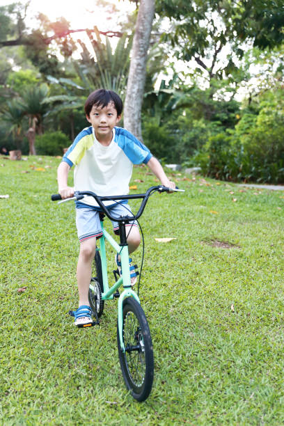 istock Chinese boy riding a bike 1320322692