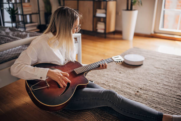 istock Woman playing guitar 1320324389