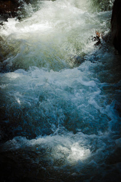 istock Intense light reflex on fast flow of clean and fresh mountain river. 1320324785