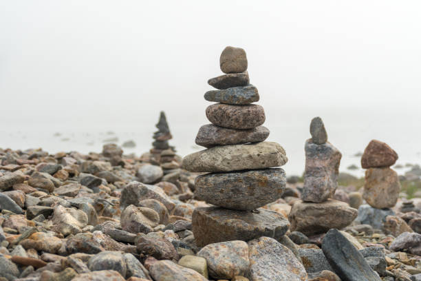 istock Stack of stones cairn on foggy beach 1320324871