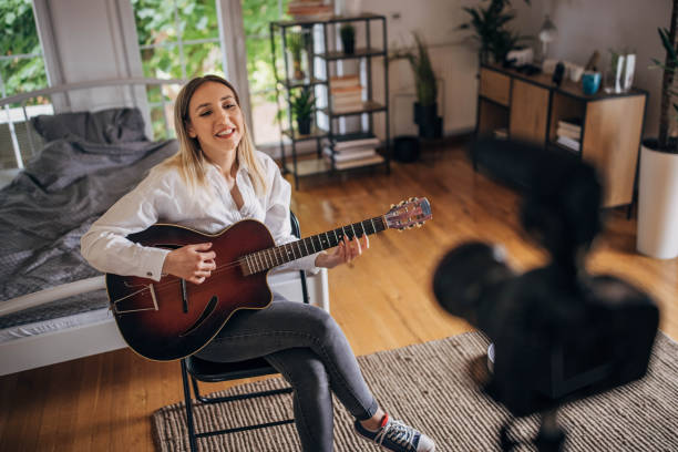 istock Woman giving online guitar classes 1320325435