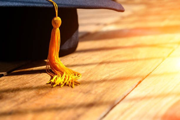 istock Black Graduation Hat placed on Old wood background 1320328099