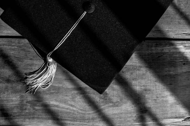 Black Graduation Hat placed on Old wood background