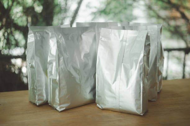 Two bags with specialty coffee indoors of a cogfee roaster.