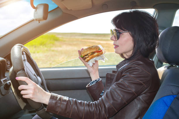 istock A woman has breakfast in a car salon on her way to work 1320328444