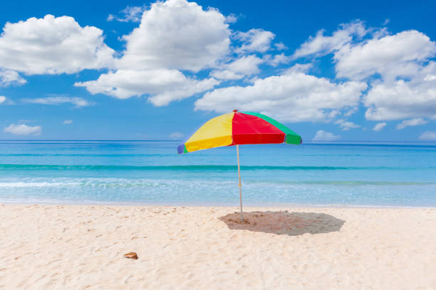 istock A colourful umbrella on white beach 1320330451