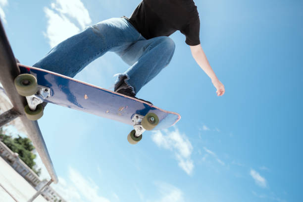 istock Asian skateboarder in action mid air 1320332306