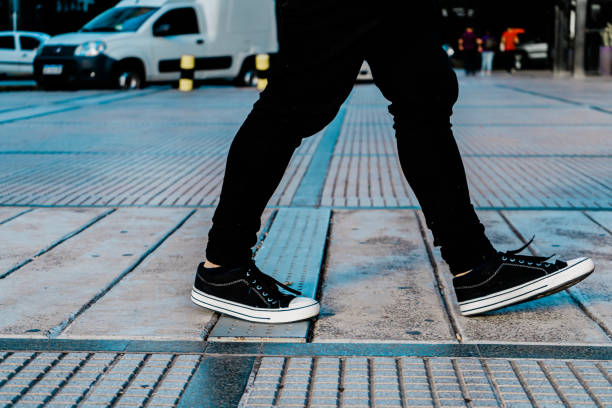 istock Young man walking down the sidewalk in a city. 1320335288