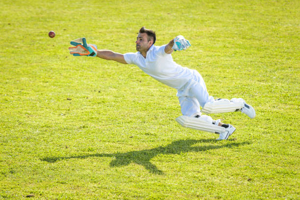 istock Male wicketkeeper attempting to catch the ball 1320338909
