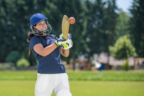 istock Female cricket player hitting the ball with her bat 1320338912