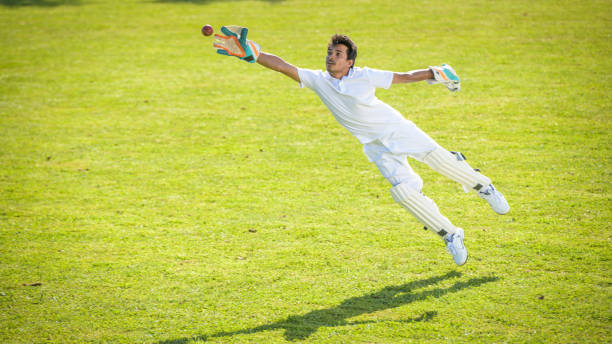 istock Male wicketkeeper attempting to catch the ball 1320338918