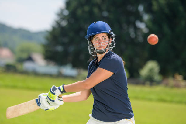 istock Female cricket player hitting the ball with her bat 1320338921