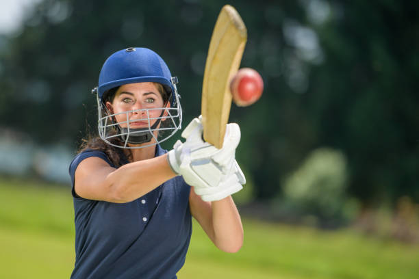 istock Female cricket player hitting the ball with her bat 1320338922