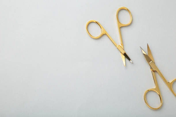 istock Scissors for manicure woman nails on grey background with copy space 1320338978
