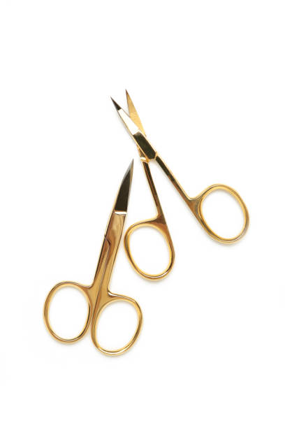 istock Small gold manicure scissors isolated on white background 1320339074