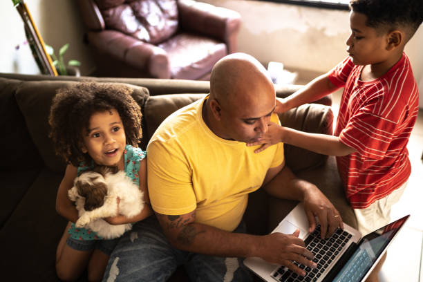 istock Father trying to work with kids annoying him at home 1320342006