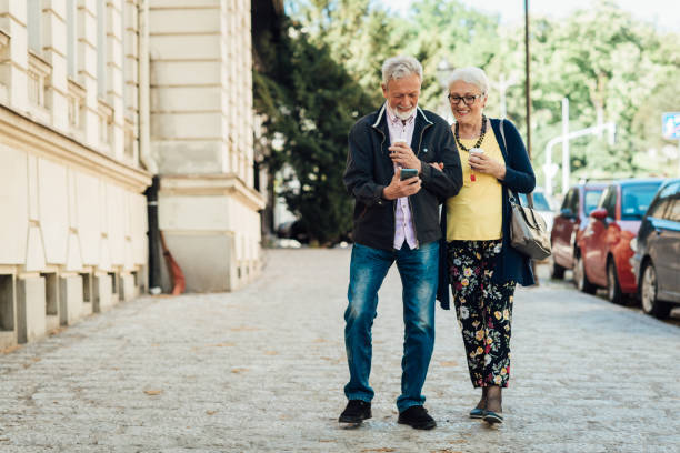 istock Happy senior couple using smartphone on the move 1320342013