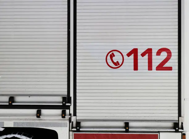Number 112 on the firetruck. Common european and worldwide emergency number on the vehicle of the emergency services brigade.