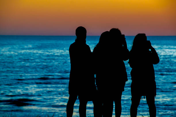 istock People at Beach Sunset Silhouette Scene 1320342907